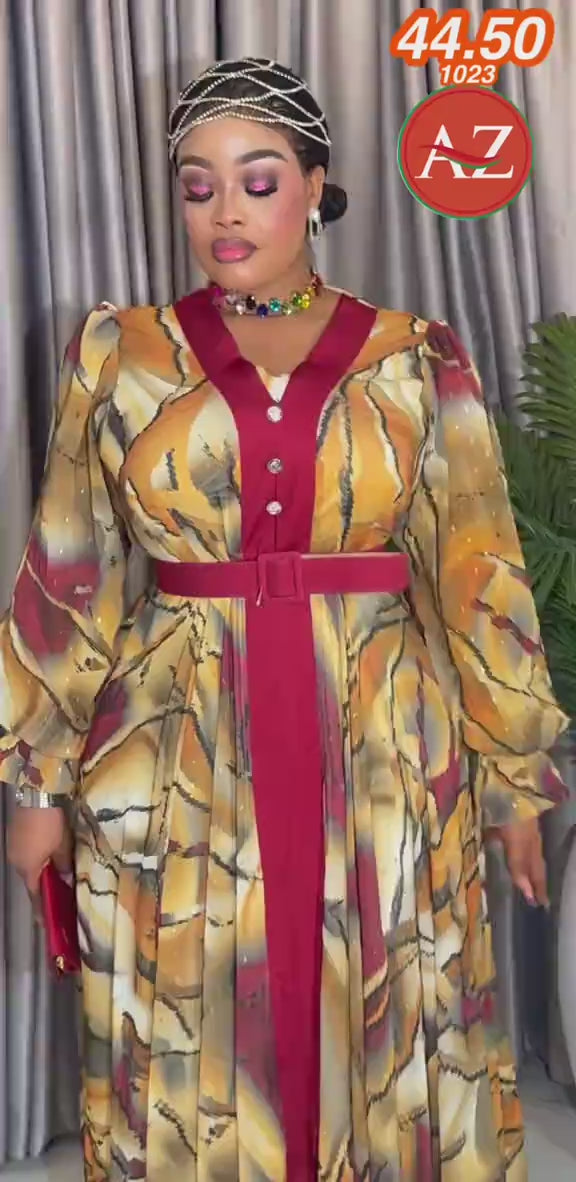 This a Casie address plus size chiffon mixi dress featuring a yellow and burgundy printe with a matching belt waist